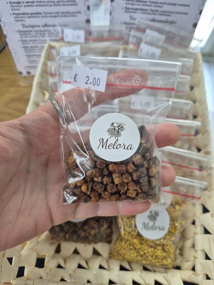 rankoje laikoma 25g. bičių duonelės supilta į plastikinį krepšiuką.